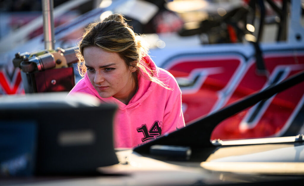 Lacey Walker working on her dad's car in the Pit Area