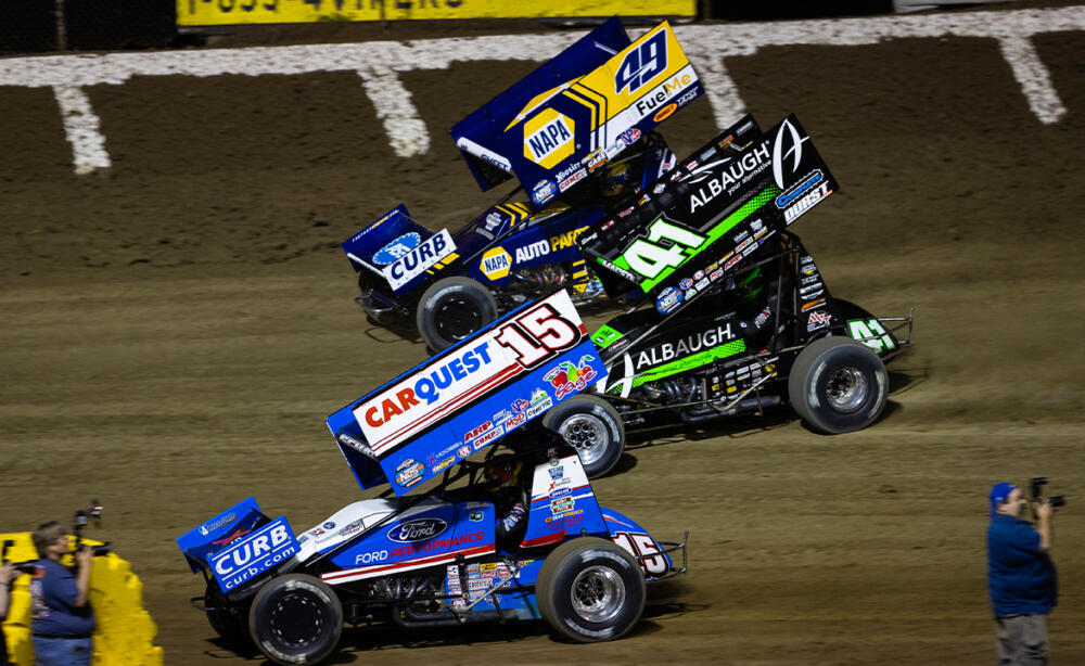 Brad Sweet, Carson Macedo, and Donny Schatz race three wide at Federated Auto Parts Raceway at I-55.