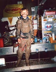A young Sheldon Haudenschild with mud covering him after a dirt bike race