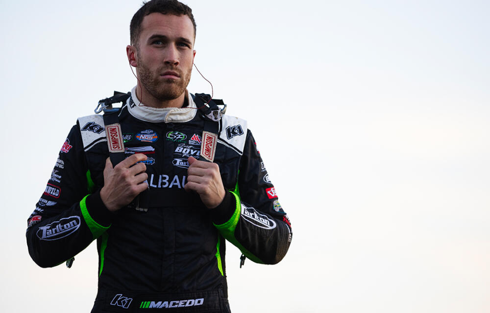 Carson Macedo standing with his racing suit on