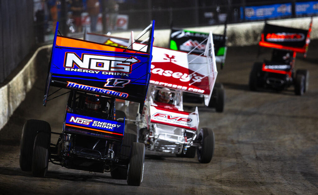 A pack of World of Outlaws NOS Energy Drink Sprint Cars racing