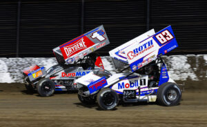 Michael "Buddy" Kofoid and Logan Schuchart race side by side