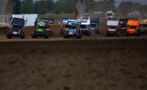 A group of World of Outlaws NOS Energy Drink Sprint Cars race at Attica Raceway Park