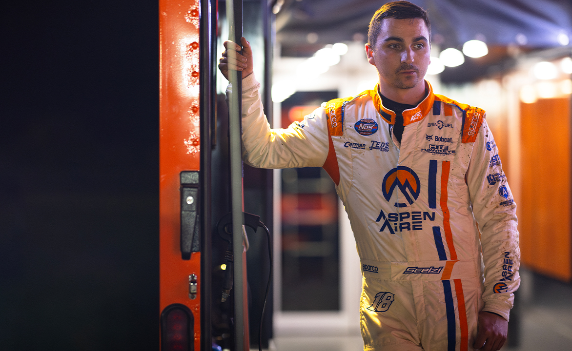 Gio Scelzi standing in the KCP Racing hauler