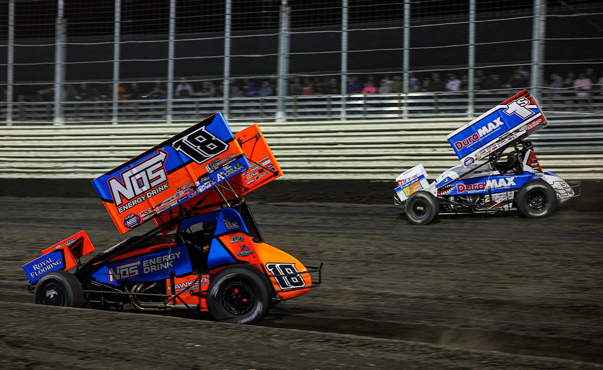 Logan Schuchart and Sheldon Haudenschild race side by side at Jackson Motorplex