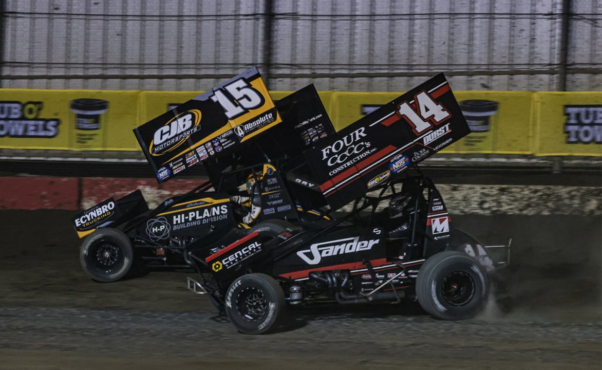 Donny Schatz races next to Corey Day at Bakersfield Speedway