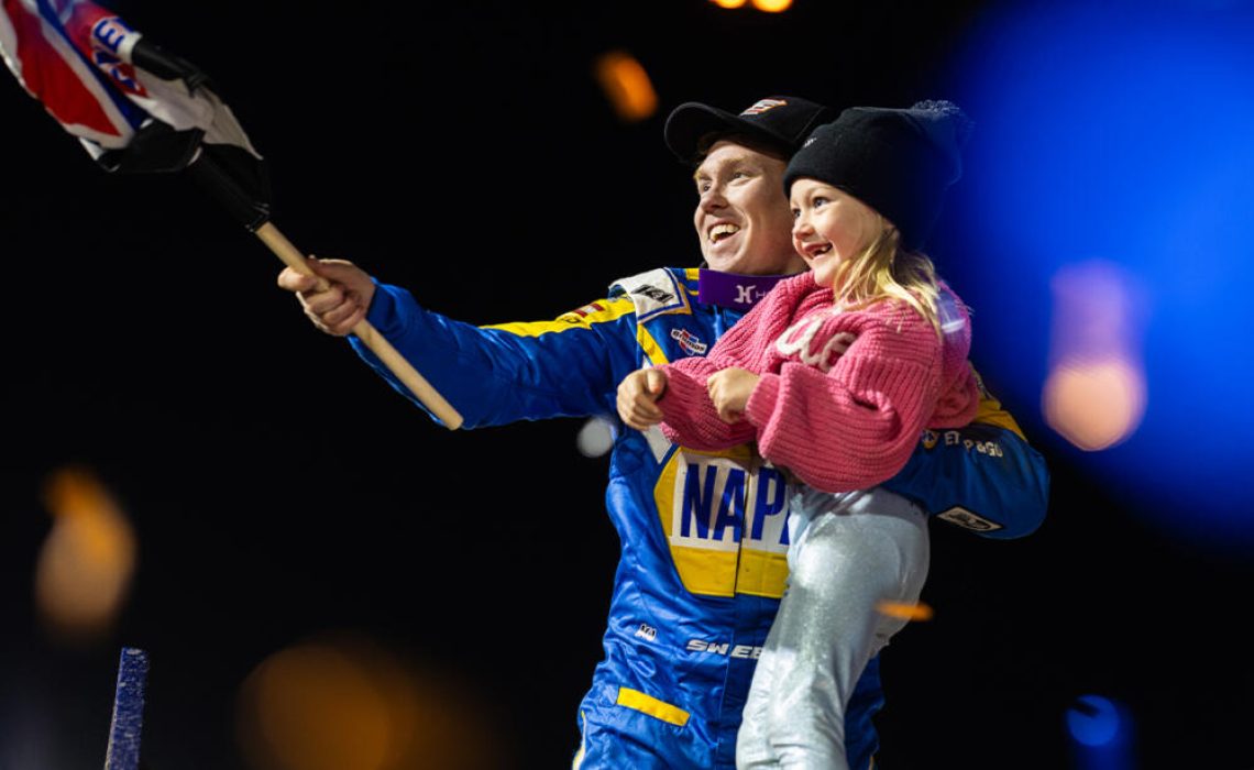 Brad Sweet celebrates with his daughter atop his wing at Volusia Speedway Park